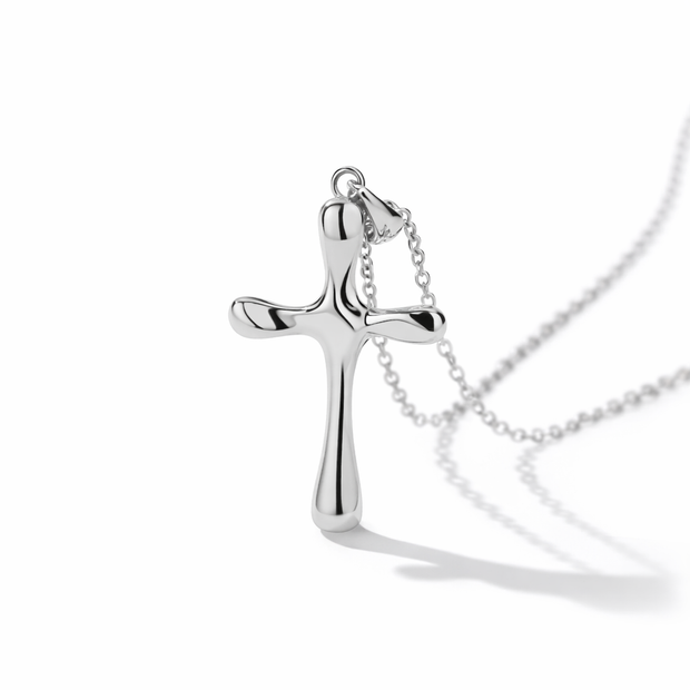 Silver cross necklace on a white background